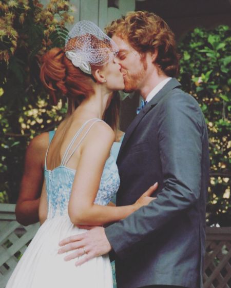 Julie McNiven and Michael Blackman Beck kissing on their wedding day.