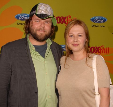 Carrie Ruscheinsky in skin colored top alongside his renowned husband, Tyler Labine. 