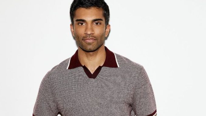 Dashing Nikesh Patel in a faded greyish t-shirt with dark red neck color.