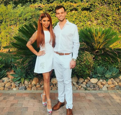 Ben Hausdorff in white shirt and pant with partner Kirtin in white dress