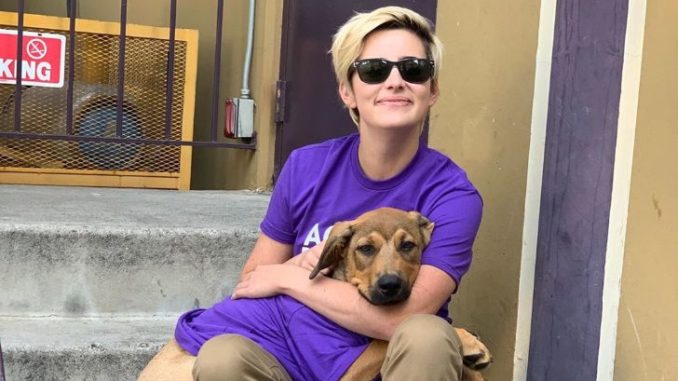 Jacqueline Toboni in a purple t-shirt with dog.