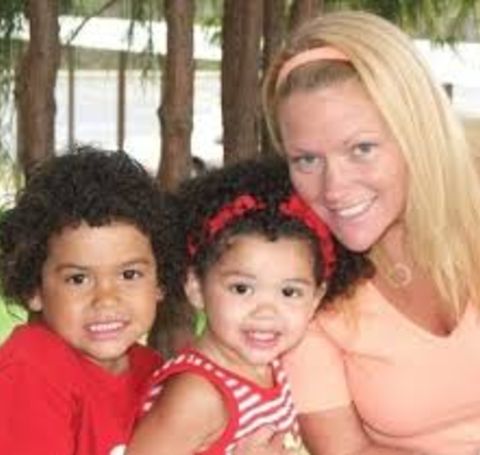 Libby Offutt in a skin colored t-shirt with two daughters.