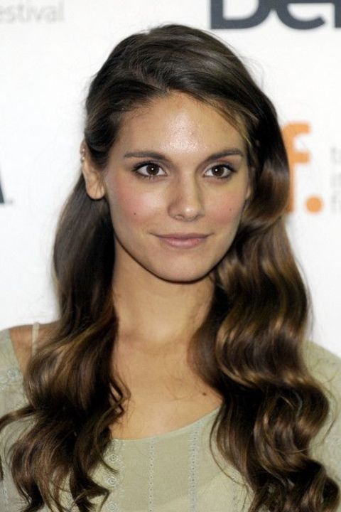 Caitlin Stasey giving a pose while attending an event.