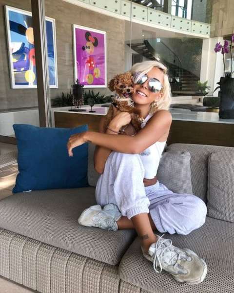 Instagram star, Tiffany Bondoc holding her pet dog.
