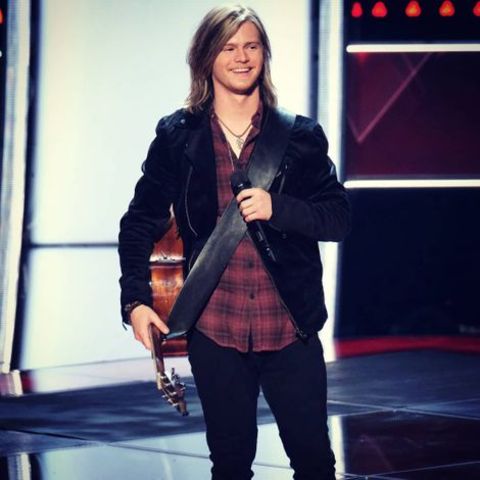Jake Haldenvang holding his guitar at The Voice.