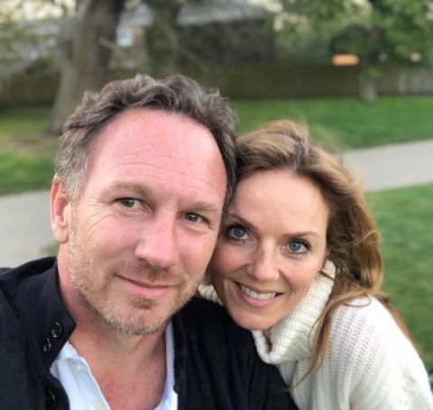 Christian Horner in black jacket takes a selfie with wife.