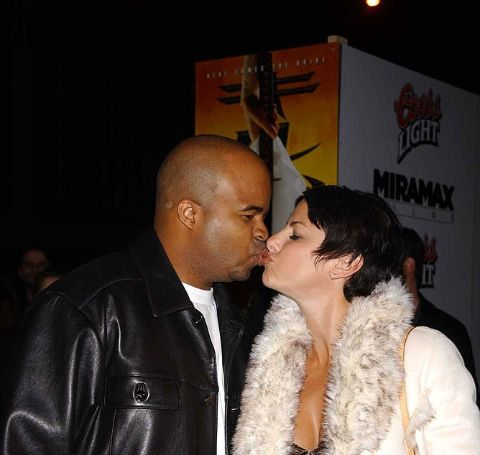 Natalie Raitano kissing her husband in an event.