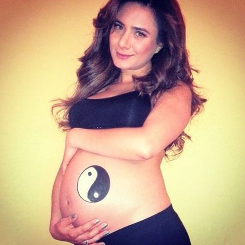Johanna Fadul holding her baby bump.