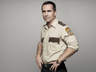 Nestor Carbonell in a police costume.