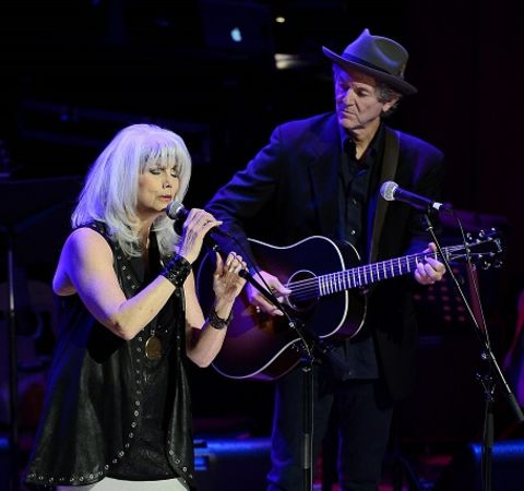Emmylou Harris and her ex-husband Paul Kennerley performing at a concert.