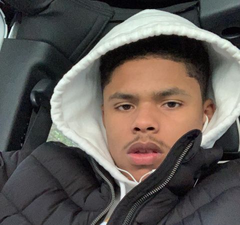 Shakur Stevenson in a black jacket and white hoodie in his car.