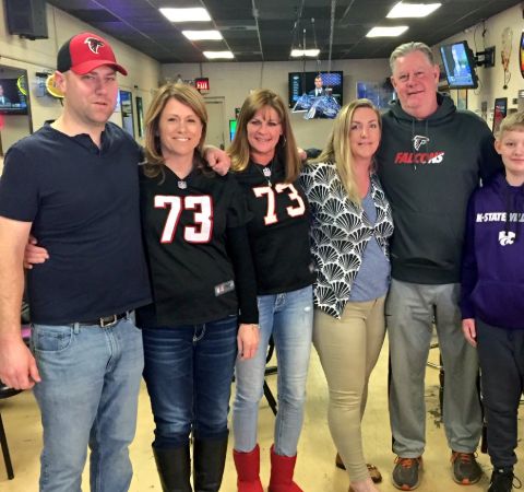 Elliott Polakoff with the family of Atlanta Falcons while reporting for Fox Kansas.