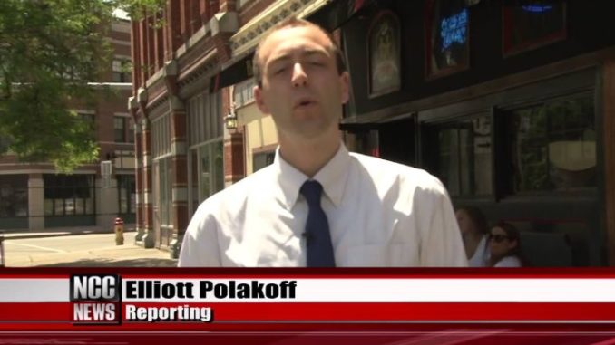 ESPN reporter Elliott Polakoff in a white shirt while reporting a news.