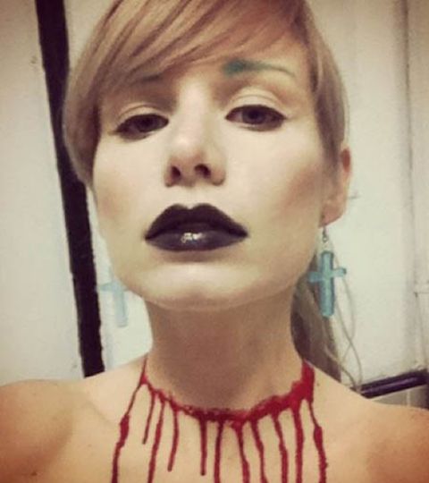 Elizabeth Ashley Wharton posted a picture in her Instagram with a nail polish art in her neck resembling a 3d tattoo of her neck getting slit by a knife.