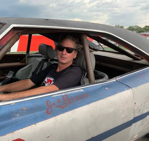 Steve Dulcich in a blue vintage car.