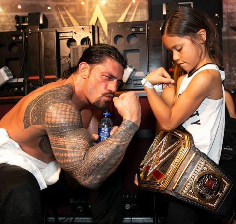 Joelle Anoa'i wears her father's WWE belt alongside her dad.