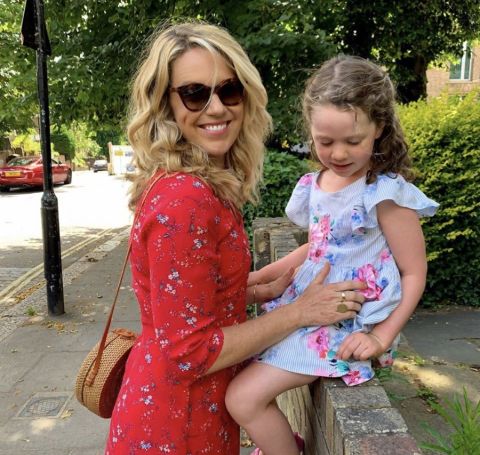 Jessica St.Clair in a red outfit with daughter 