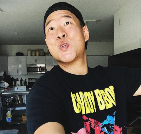 David So in a black t-shirt poses for a selfie.