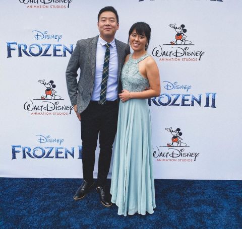 David So in a grey suit with fiance Mariel Song in a light blue dress.