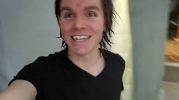 Onision in a black t-shirt poses for a selfie.