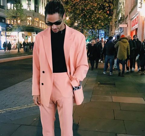 Bluey Robinson in a pink suit poses for a picture.