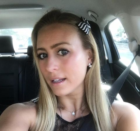 Angelique Kenney in a car poses for a selfie.