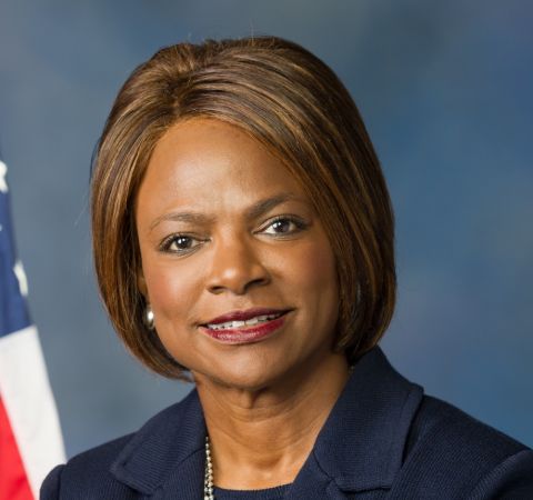 Val Demings in a black coat poses for a photoshoot.