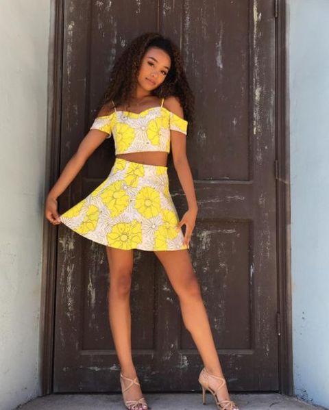 Genneya Walton giving a pose in a yellow colored dress.