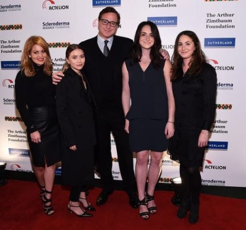 Sherri Kramer's ex-husband poses with their daughters at an event.