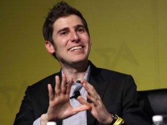 Eduardo Saverin in a black suit caught on camera during a seminar.