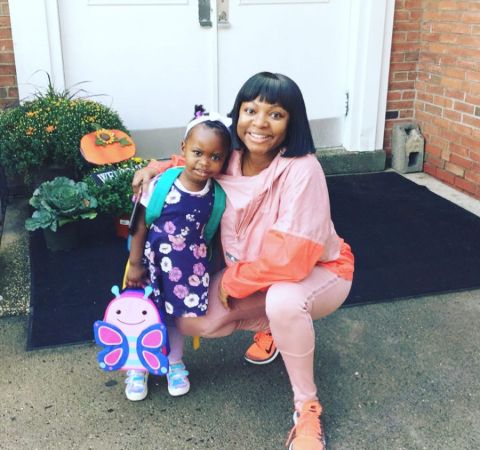 Naturi Naughton in a pink dress poses a picture alongside her daughter.