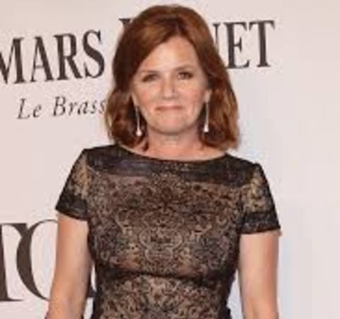 Mare Winningham in a black cloth poses for  a picture.
