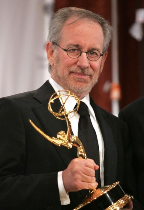 Steven Spielberg giving a pose while holding his Emmy Award.