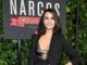 Fernanda Urrejola in a black dress poses at the premiere of Netflix season 2.