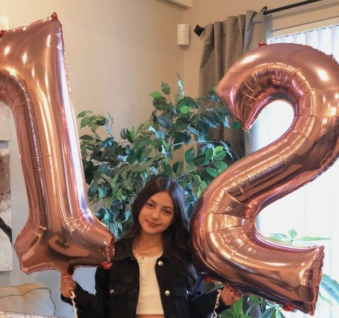 Elle Paris Legaspi in a black jacket celebrates her 12th birthday.