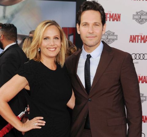 Julie Yaeger in a black dress poses with a actor cum husband Paul Rudd.