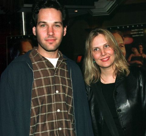 Julie Yaeger in a black t-shirt poses with husband Paul Rudd.