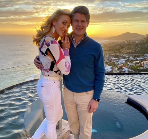 Tavia Hunt in a colourful shirt poses with husband Clark Hunt.