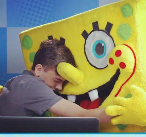 Jaxon React hugging  a sponge-bob doll.