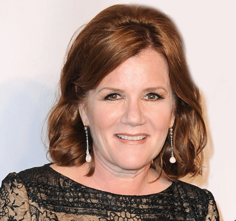 Mare Winningham in a black cloth in  poses for a  picture.