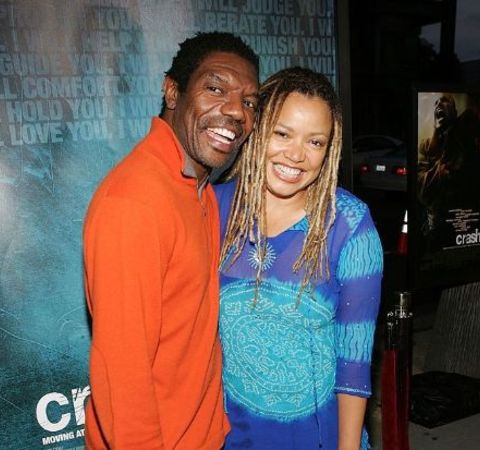 Kasi Lemmons in a blue dress with husband.