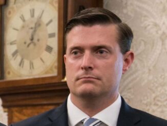 Rob Porter in a black suit caught in the camera.