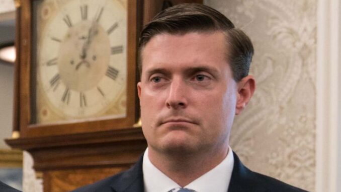Rob Porter in a black suit caught in the camera.