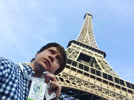 Calum Worthy in front of Eiffel Tower