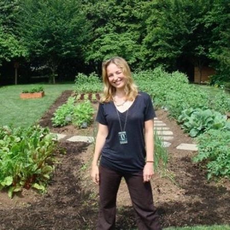 Colombe Jacobsen-Derstine in front of her vegetable garden
