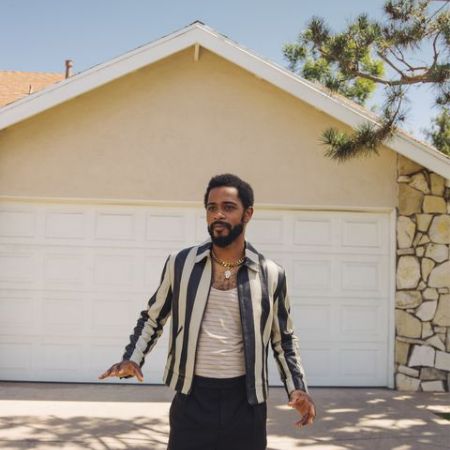 LaKeith standing in front of his house
