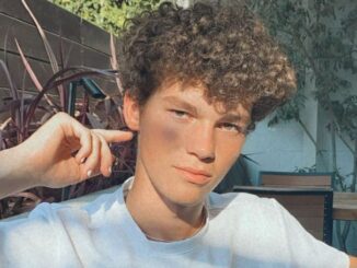 Hayden Summerall wearing a white t-shirt and posing for a photo.