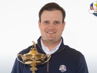Zach Johnson is holding his trophy.