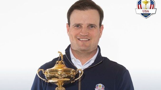 Zach Johnson is holding his trophy.