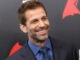 Zack Snyder is smiling for a photo.